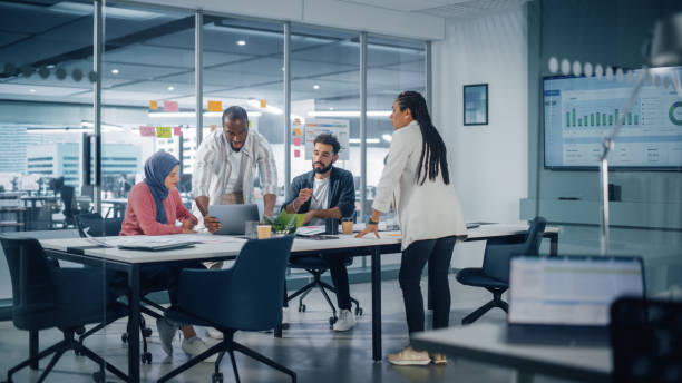 featured-image-1770778809 Multi-Ethnic Office Conference Room Meeting: Multicultural Team of Four Creative Entrepreneurs Talk, Discuss Growth Strategy. Diverse Young Businesspeople work on Digital e-Commerce Startup.